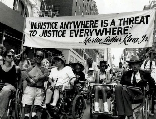 Photo credit: Judy Heumann pictured alongside members of Disabled In Action, a disability justice organization she founded, protesting the delaying of the passing of Section 504 in Madison Avenue, New York in 1970. (Source: Tari Hartman Squire)​