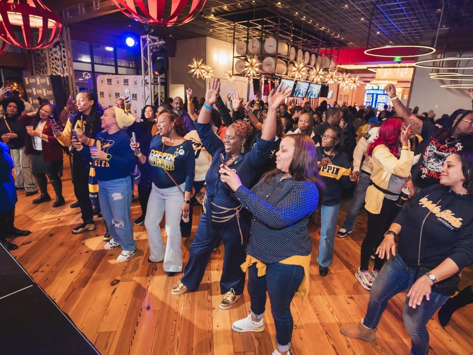 A Group Coppin alums dancing at 2025 Homecoming Happy Hour