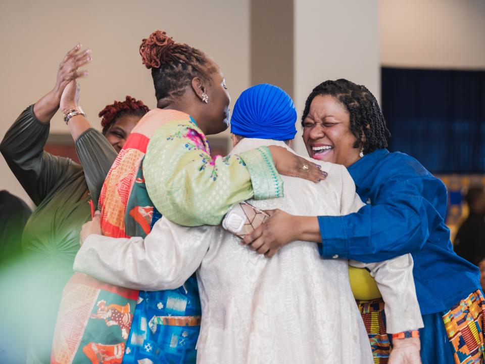 A group of Coppin alums embracing during 2025 Homecoming