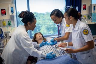 Three nursing students learning basic techniques