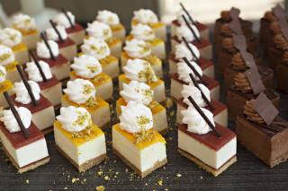 Small chocolate and vanilla layered cakes in rows