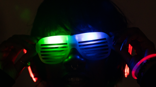 Student wearing glow in the dark sunglasses.